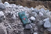 一台雷射測量儀放在建築工地的一堆岩石上。