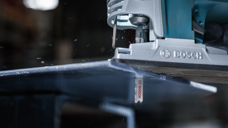 車間裡，拼圖鋸正在切割金屬板。