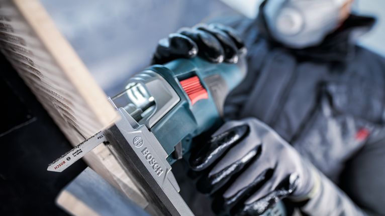 PRO Soft Tile T130RF 線鋸片,83 mm,3 件 配戴安全設備的人員使用往復鋸切割木板。